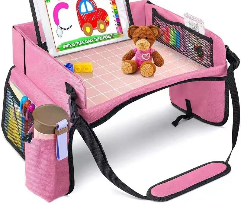 Trekkaboo Travel Tray in Blush Pink with a teddy bear on the play surface and bottle in the cup holder
