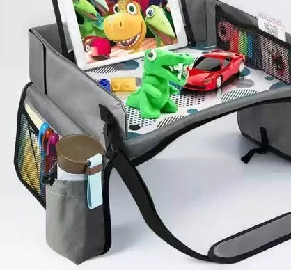 Trekkaboo Travel Tray in Slate Gray with a tablet in the fold-out stand and toys on the play surface